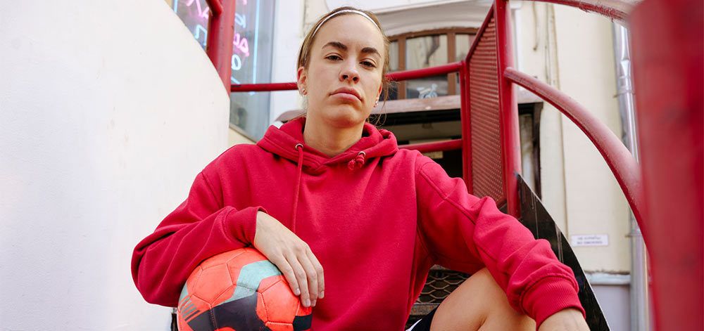 Woman sitting with a soccer ball