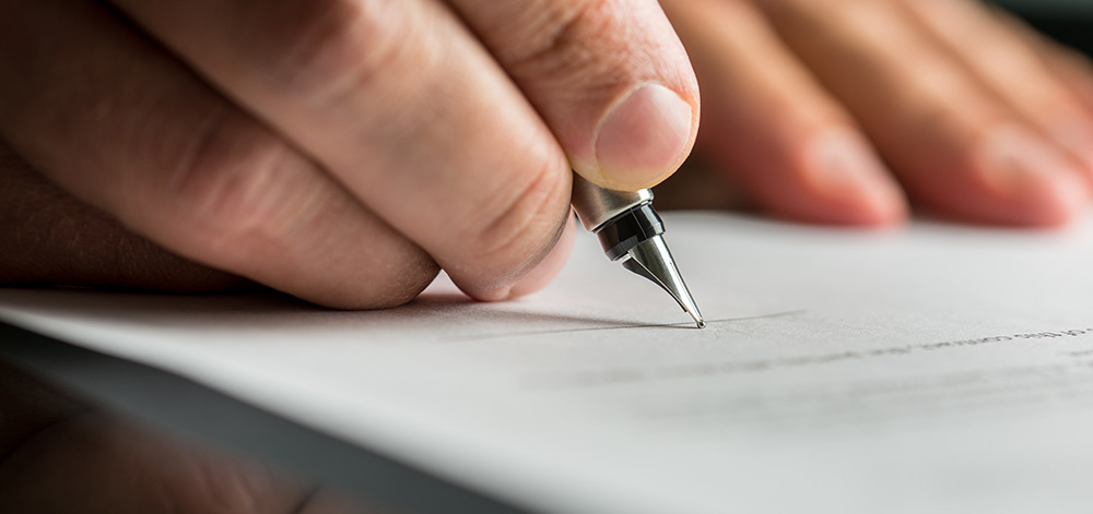 Someone writing with a pen