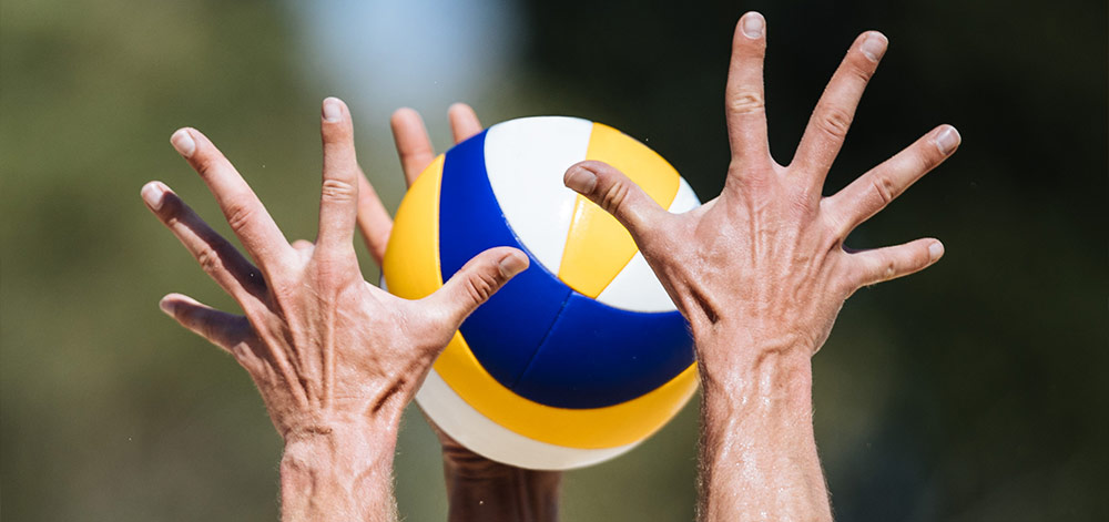 Hands setting a volleyball