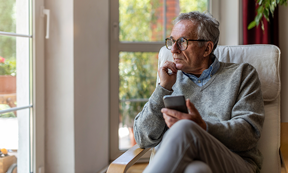 Older man looking out a window