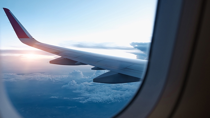 View of sunrise out of a plane window