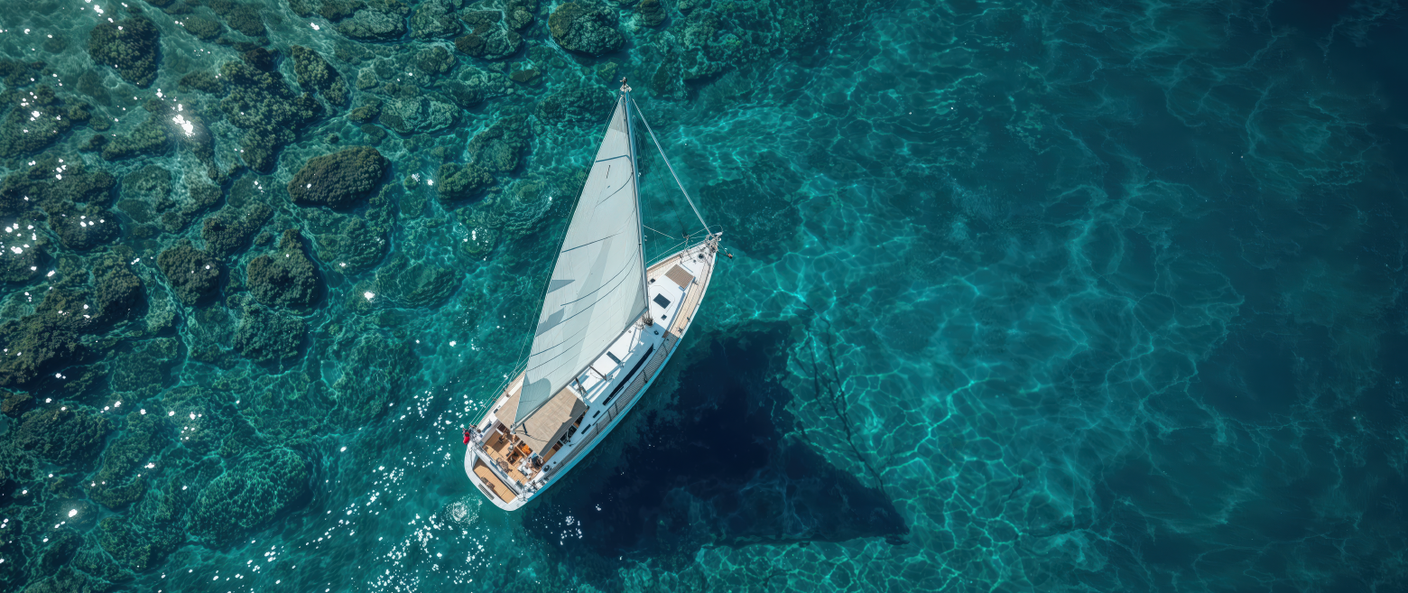 Bird eye view of sailboat in ocean
